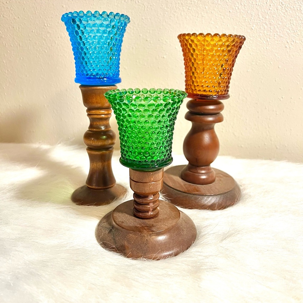 3 assorted bubble scones on various wooden candlesticks light blue, amber, green
